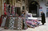 Aleppo's Great Bazaar (in Arabic, <i>suq</i> or <i>souq</i>) as we know it today was rebuilt first by the Egyptian Mamelukes who drove out the Mongols, and then, after 1516, by the Turks who incorporated Aleppo into the Ottoman Empire.<br/><br/>

During the Syrian Civil War, which started in 2011, Aleppo's historic <i>suqs</i> suffered serious damage.<br/><br/>

Aleppo, the second city of Syria and quite possibly the longest continually inhabited settlement in the world, is of venerable age. So old, indeed, that its Arabic name, Halab, is first mentioned in Semitic texts of the third millennium BCE. Situated in the north-west of the country, just a few kilometres from the Turkish frontier, Aleppo is located at the confluence of several great trade routes and, as a city of commerce, has always been rich.