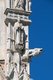Italy: Saint and gargoyle, facade right, Cathedral of Saint Mary of the Assumption (Duomo di Siena), Siena