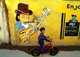 India: A young boy poses in front of a wall mural, Diu, union territory of Daman and Diu (1998)