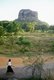 Sri Lanka: A woman passes Sigiriya (Lion's Rock)