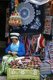 China: A Bai woman sews a bag at her handicraft stall in Dali, Yunnan