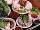 Vietnam: <i>Nem nuong</i> or grilled Vietnamese pork sausage with rice, served with noodles, rice paper, fresh vegetables, herbs and garlic, accompanied by a peanut sauce, fried and fresh spring rolls, and fermented pork