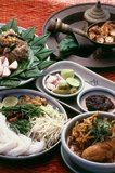 The food of Northern Thailand, like the language, traditional dress and architecture, is quite distinct from that of Bangkok and central Thailand.<br/><br/>

Northern Thai cuisine differs from central Thai cuisine in that it is clearly influenced by the traditions of neighbouring Burma, Laos and Yunnan. To begin with, the staple is not <i>khao suai</i>, the soft, fragrant boiled rice of the central plains so familiar to Westerners. Instead, the Khon Muang prefer to eat <i>khao niaw</i>, or glutinous sticky rice. This is steamed, served in tiny wicker baskets, and eaten with the fingers along with a selection of  spicy dips and curries.