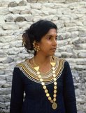 The <i>dhivehi libaas</i> is a traditional Maldivian dress for women. The neckline is adorned with what is called <i>Kasabu viyun</i>, a collar hand stitched with silver and gold laces.<br/><br/>

On the eastern rim of the South Nilandhoo Atoll lies the tiny island of Rinbudhoo. Here, in one of the quietest and cleanest villages in the Maldives, lives the country's only group of hereditary goldsmiths. Melting down Victorian gold sovereigns and Marie-Therèse thalers as casually as recently-imported mini-ingots from Dubai, they manufacture an exquisite range of chains, necklaces, ear-rings, finger-rings and amulets.<br/><br/>

Asia's smallest and least-known nation, the Republic of Maldives, lies scattered from north to south across a 750-kilometre sweep of the Indian Ocean 500 kilometres south-west of Sri Lanka. More than 1000 islands, together with innumerable banks and reefs, are grouped in a chain of nineteen atolls which extends from a point due west of Colombo to just south of the equator.