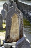 In the Maldives, being a Muslim country, people are buried. Tombstones with a single point on the top are those of men, while those with a rounded top are those of women.<br/><br/>

Asia's smallest and least-known nation, the Republic of Maldives, lies scattered from north to south across a 750-kilometre sweep of the Indian Ocean 500 kilometres south-west of Sri Lanka. More than 1000 islands, together with innumerable banks and reefs, are grouped in a chain of nineteen atolls which extends from a point due west of Colombo to just south of the equator.<br/><br/>

The atolls, formed of great rings of coral based on the submarine Laccadive-Chagos ridge, vary greatly in size. Some are only a few kilometres square, but in the far south the great atoll of Suvadiva is sixty-five kilometres across, and has a central lagoon of more than 2000 square kilometres. The northern and central atolls are separated from each other by comparatively narrow channels of deep water, but in the south Suvadiva is cut off by the eighty-kilometre-wide One-and-a-half-Degree Channel. Addu Atoll is still more isolated, being separated from the atoll of Suvadiva by the seventy-kilometre-wide Equatorial Channel.