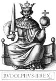 Rudolf I (1218-1291), also known as Rudolf of Habsburg, was the son of Count Albert IV of Habsburg, and became count after his father's death in 1239. His godfather was Emperor Frederick II, to whom he paid frequent court visits. Rudolf ended the Great Interregnum that had engulfed the Holy Roman Empire after the death of Frederick when he was elected as King of Germany in 1273.<br/><br/>

Rudolf secured the recognition of the Pope by promising to launch a new crusade and renouncing all imperial rights to Rome, the papal territories and Sicily. His main opponent was King Ottokar II of Bohemia, who had refused to acknowledge Rudolf as King of Germany. War was declared against Ottokar in 1276, and he was defeated and killed in 1278 during the Battle on the Marchfeld.<br/><br/>

Rudolf was ultimately not entirely successful in restoring internal peace throughout the Holy Roman Empire, lacking the power, resources and determination to truly enforce his established land peaces, with the princes largely left to their own devices. He died in 1291, establishing the powerful Habsburg dynasty but unable to ensure the succession of his son Albert as German king.