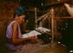 Burma / Myanmar: An elderly Jinghpaw (Kachin) weaver using a backstrap loom, Kachin State (1997)