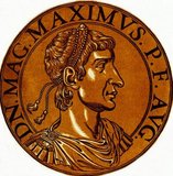 Magnus Maximus (335-388) was born in Gallaecia, and would later become a distinguished general serving under Count Theodosius, father of Emperor Theodosius I, fighting in Africa and on the Danube, as well as during the Great Conspiracy in Britain, where he would later be permanently assigned in 380.<br/><br/> 

When the people became displeased with the western emperor Gratian, his troops proclaimed Maximus emperor, and aided him in his imperial ambitions. Gratian was slain in Lyon, and Maximus later marched into Italy to overthrow Valentinian II. He was only stopped by the intervention of the Eastern Roman Emperor, Theodosius I, who negotiated with him and saw Maximus recognised as co-emperor in the west.<br/><br/>

Maximus' ambitions could not be quelled however, and he invaded Italy once more in 387, only to be finally defeated and killed by Theodosius I at the Battle of the Save in 388. To some historians, Maximus' death marked the end of direct imperial presence in Northern Gaul and Britain.