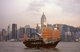 China: A junk crosses Victoria Harbour with Hong Kong's third highest building, Central Plaza rising in the background