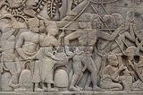 Cambodia: A woman pokes a turtle into a soldier's bottom giving him a shock as the Khmer army advances, bas-relief Eastern Wall, southern section, The Bayon, Angkor Thom.<br/><br/>

The Bayon was originally the official state temple of the Mahayana Buddhist King Jayavarman VII. The Bayon, at the centre of Angkor Thom (Great City), was established in the 12th century by King Jayavarman VII.<br/><br/>

Angkor Thom, meaning ‘The Great City’, is located one mile north of Angkor Wat. It was built in the late 12th century CE by King Jayavarman VII, and covers an area of 9 km², within which are located several monuments from earlier eras as well as those established by Jayavarman and his successors. It is believed to have sustained a population of 80,000-150,000 people.