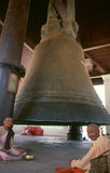 Burma / Myanmar: Buddhist nuns at the Mingun Bell in Sagaing Division, Burma. The Mingun Bell is a giant bell located in Mingun, on the western bank of the Irrawaddy River, Sagaing Region, Myanmar. It was the heaviest functioning bell in the world at several times in history. The weight of the bell is 90,718 kg or 199,999 pounds. The bell is uncracked and in good ringing condition. Casting of the bell started in 1808 and was finished by 1810. King Bodawpaya (r. 1782–1819) had this gigantic bell cast to go with his huge stupa, Mingun Pahtodawgyi.