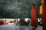 Burma / Myanmar: Buddhist monks inspect the inside of the Mingun Bell in Sagaing Division, Burma. The Mingun Bell is a giant bell located in Mingun, on the western bank of the Irrawaddy River, Sagaing Region, Myanmar. It was the heaviest functioning bell in the world at several times in history. The weight of the bell is 90,718 kg or 199,999 pounds. The bell is uncracked and in good ringing condition. Casting of the bell started in 1808 and was finished by 1810. King Bodawpaya (r. 1782–1819) had this gigantic bell cast to go with his huge stupa, Mingun Pahtodawgyi.