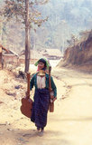 Thailand: Padaung (Long Neck Karen) woman carrying homemade guitars, village near Mae Hong Son, northern Thailand. The Padaung or Kayan Lahwi or Long Necked Karen are a subgroup of the Kayan, a mix of Lawi, Kayan and several other tribes. Kayan are a subgroup of the Red Karen (Karenni) people, a Tibeto-Burman ethnic minority of Burma (Myanmar).