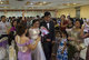 Cambodia: Cambodian Wedding Reception. Guests shower bride and groom with petals as they walk to the stage.